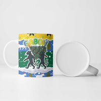 Gabon Christmas Ceramic Mug with Black Panthers Carrying Tree and Green Yellow Snowflake Pattern - Wonder Print Shop