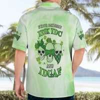 Green Hawaiian shirt on adult, back view with skull-and-clover slogan print, short sleeves