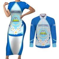Nicaragua National Emblem Couples Matching Short Sleeve Bodycon Dress and Long Sleeve Button Shirt with White Flor de Sacuanjoche and Blue Gradient Design - Wonder Print Shop