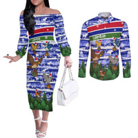 Gambia Christmas Couples Matching Off The Shoulder Long Sleeve Dress and Long Sleeve Button Shirt with Santa Birds Gift Boxes Forest Scene and Snowflake Pattern Design - Wonder Print Shop