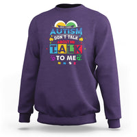 Purple sweatshirt with colorful Autism slogan: "Don't Talk About Me, Talk To Me".