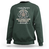 Dark forest green crewneck sweatshirt with 'Automation Engineer' graphic and gear badge.