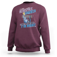 Maroon crewneck sweatshirt with space engineer graphic and slogan on the front, long sleeves.
