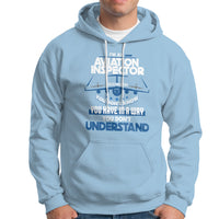 Light blue hoodie with aviation-themed “Inspector” graphic on the chest and front pocket.