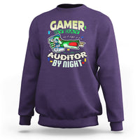 Purple crewneck sweatshirt with “GAMER BY DAY” and “AUDITOR BY NIGHT” chest graphic.