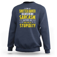 Navy crewneck sweatshirt with yellow “Sarcasm” driver graphic on the chest
