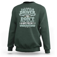 Dark forest green crewneck sweatshirt with large front “Shutter Driver” graphic print.