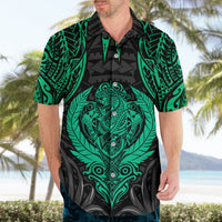 Mens Hawaiian shirt with short sleeves; black base and green tiki emblem on front
