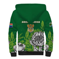 Green sherpa hoodie with front graphic, white protea print, ribbed black hem and cuffs
