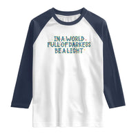 In A World Full Of Darkness Be A Light Raglan Shirt Christmas Quote Gift - Wonder Print Shop