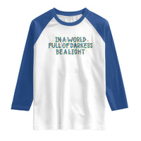 In A World Full Of Darkness Be A Light Raglan Shirt Christmas Quote Gift - Wonder Print Shop