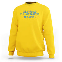 In A World Full Of Darkness Be A Light Sweatshirt Christmas Quote Gift - Wonder Print Shop