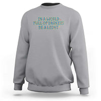 In A World Full Of Darkness Be A Light Sweatshirt Christmas Quote Gift - Wonder Print Shop