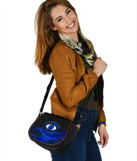 Blue evil eye crossbody saddle bag with black edging and front flap