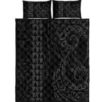 Grey quilt bed set with geometric triangles and swirl pattern; includes two pillows