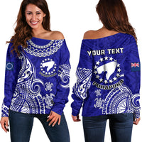Blue off-shoulder sweater with white tribal turtle print and 'YOUR TEXT'