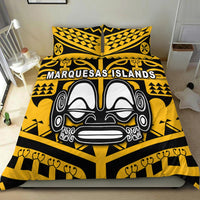 Yellow and black bedding set with tiki face artwork and “Marquesas Islands” wordmark, on bed