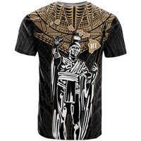 Black T-shirt with gold tribal print, Kamehameha portrait and “HI” emblem