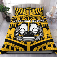 Yellow and black bedding set with “Marquesas Islands” text and tiki face graphic, on bed