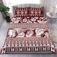Red and white patterned bedding set with tropical motifs and geometric stripe borders