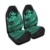 Isolated pair of turquoise tribal hibiscus-and-whale seat covers on black base