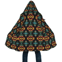 Close view of hooded cloak, dark fabric with red-yellow and teal geometric pattern