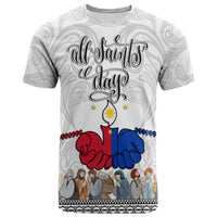 White crewneck T-shirt with “All Saints Day” print, red/blue praying hands, figures at bottom