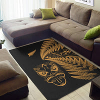 Black rug with gold tiki mask centerpiece and fern-frond design