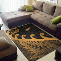 Gold leaf and swirling koru design area rug on dark base, rectangular