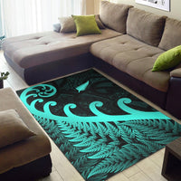 Turquoise fern and koru motif on dark green area rug with leaf border trim
