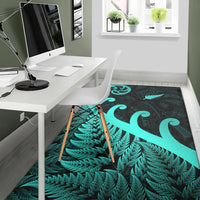 Turquoise fern row pattern and large koru swirl on dark green area rug