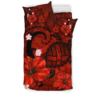 Red duvet and pillows featuring black turtle, hibiscus blooms and plumeria flowers, tribal accents