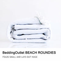 Folded plush beach towel roll in pale blue, soft terry texture