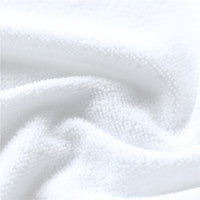 White towel texture close-up with raised loops and curved stitched pattern