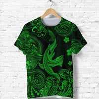 Green and dark graphic t-shirt with Polynesian shark design, tribal swirls and clover accents