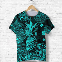 Turquoise pineapple graphic T-shirt with ornate Polynesian patterns, short sleeves