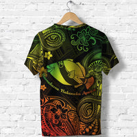 Green and orange tribal T-shirt with yellow fish graphic, flower accents, and Polynesian swirls