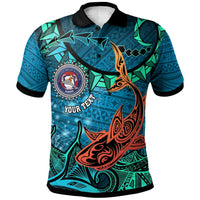 Blue custom polo shirt with black collar, tribal artwork and round school crest on front