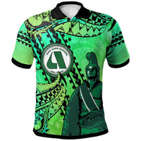 Green polo shirt with black collar and tribal graphic, circular logo on chest