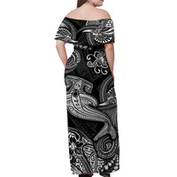 Black off-shoulder maxi dress, back view, with white Polynesian tribal wave and flower print