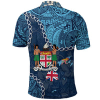 Blue polo shirt back view with crest, Union Jack, and island figures graphic