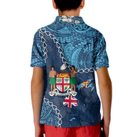 Blue polo shirt back close-up with Union Jack and crest beneath patterned panels