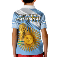 Blue football polo shirt back for kids; 'ARGENTINA CHAMPIONS' trophy and sun face graphic