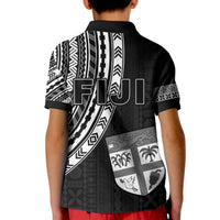 Kids black rugby polo shirt with back graphic, crest, shield icons, and geometric stripes