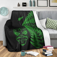 Black blanket with green fern leaves and Maori face, with white backing/trim