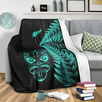 Black blanket with turquoise fern and Maori mask; light border fleece edge