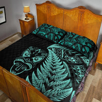 Black quilt and pillows featuring turquoise fern print and Maori geometric tribal patterns