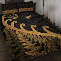 Black quilt bed set with gold fern leaf and koru scroll quilting across cover