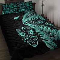 Black quilt bed set with turquoise fern leaves and Maori-style face with tribal symbols