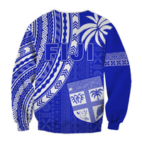 Blue crewneck sweatshirt with white patterned back, large letters, and shield graphic